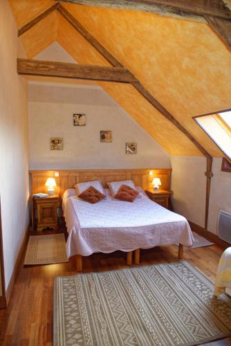 - une chambre mansardée avec un lit et 2 tables de nuit dans l'établissement Chambre d'hotes Au Vieux Moulin, à Clohars-Carnoët