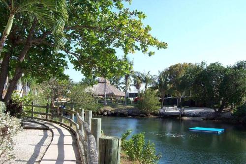 a river with a bridge and a boat in the water at SEA MIST - Oceanfront-Lake-Kayak-Paddleboard-Bike in Key Largo