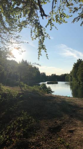 a view of a river with trees and the sky at Chateau de Bonnevaux in Villeneuve-de-Marc