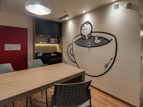 a room with a table and a drawing on the wall at Ramada Encore by Wyndham Monterrey Apodaca Zona Aeropuerto in Monterrey