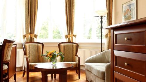 - un salon avec une table, deux chaises et un canapé dans l'établissement Villa Stella Maris, à Międzyzdroje