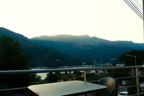 a balcony with a table and a view of a mountain at Casa do Lago - Geres in Geres
