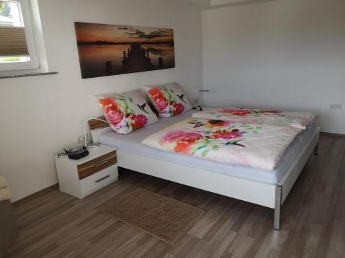 a bedroom with a bed with flowers on it at Ferienwohnung Zur Waldkapelle in Nohfelden