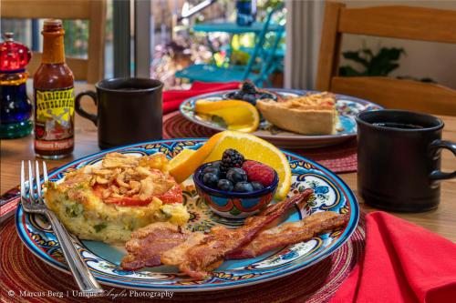 a table with a plate of breakfast food on a table at Adobe Rose Inn in Tucson