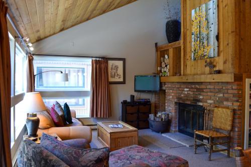 a living room with a couch and a fireplace at Remodeled 2 Bedroom East Vail Condo 6G with Hot Tub Market Free Shuttle in Vail