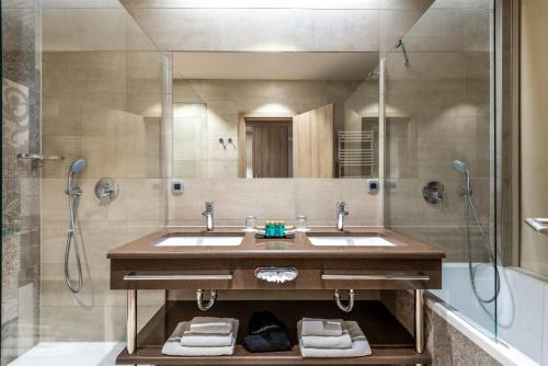a bathroom with two sinks and a shower at Hotel Plaža Duće in Omiš