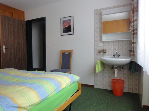 a bedroom with a bed and a sink at Adular in Saas-Fee