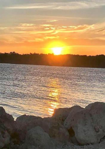 a sunset over a large body of water at SEA MIST - Oceanfront-Lake-Kayak-Paddleboard-Bike in Key Largo