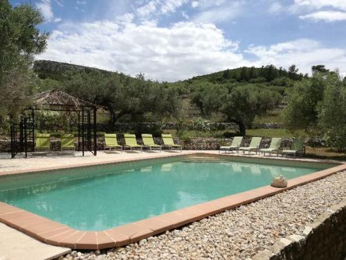 a swimming pool with lounge chairs at Casita Blanca in Perelló