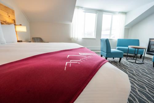 a hotel room with a bed and two chairs at Mountain Inn at Killington in Killington