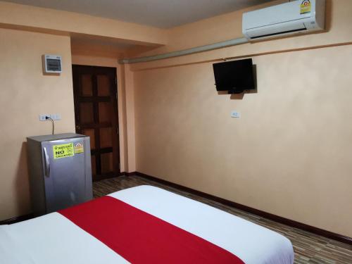 a room with a bed and a tv on the wall at Bankaina in Hua Hin