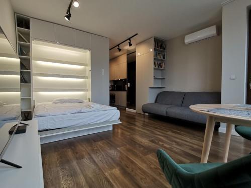 salon z łóżkiem i kanapą w obiekcie Nowoczesny Apartament z widokiem w Warszawie