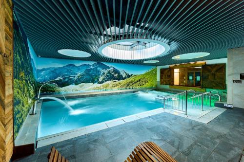 a painting of a swimming pool in a museum at Aparthotel Giewont in Zakopane