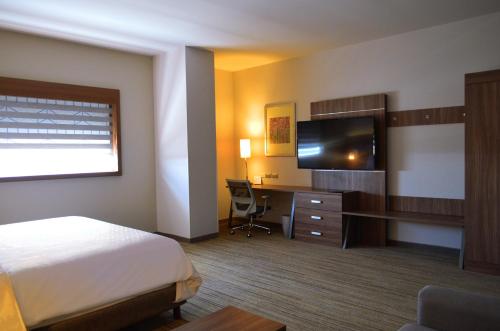 a hotel room with a bed and a desk and a television at Holiday Inn Express & Suites - Ciudad Obregon by IHG in Ciudad Obregón