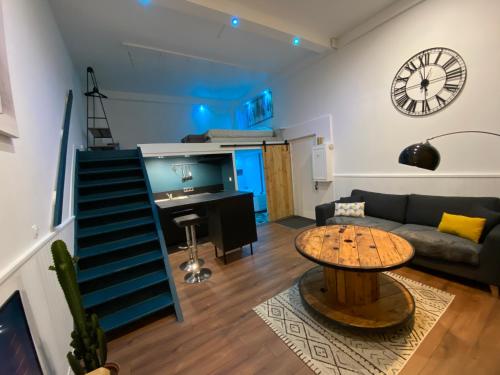 a living room with a couch and a table at LH Évasion loft pour 2 avec balnéo in Le Havre