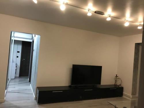 a living room with a flat screen tv on a wall at ELEGANT & SILVER LUXURY Apartament in Craiova