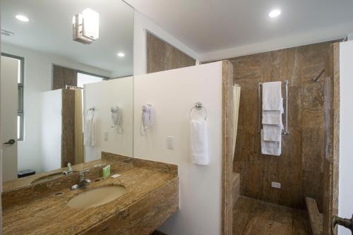 a bathroom with a sink and a shower at Balmoral Hotel San José CR, Historic District in San José