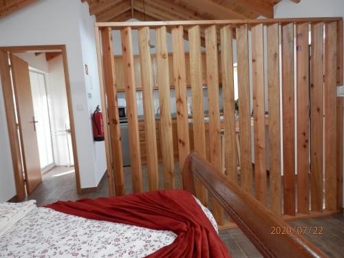 a room with a staircase with wooden walls and a bed at Adega Jaquet in Biscoitos