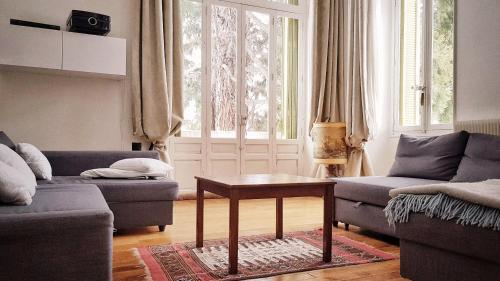 a living room with two couches and a table at VILLA SEQUOIA in Jausiers