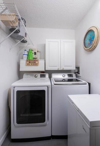a kitchen with a stove and a microwave at SEA MIST - Oceanfront-Lake-Kayak-Paddleboard-Bike in Key Largo