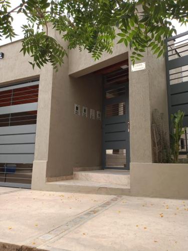 a building with two garage doors on the side of it at Departamento para 5 personas con cochera in Godoy Cruz