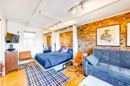 1 dormitorio con cama y pared de ladrillo en A Room With A View, en Provincetown