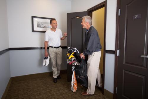 two men are standing in a room with a baby carriage at Staybridge Suites - Nashville - Franklin by IHG in Franklin