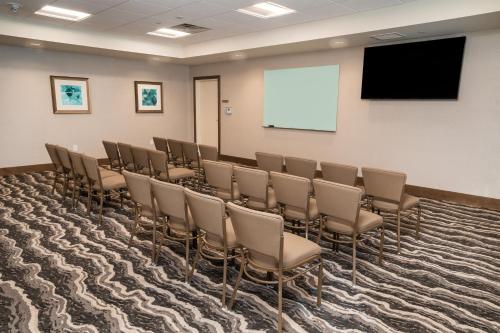 a conference room with chairs and a screen at Staybridge Suites - Nashville - Franklin by IHG in Franklin