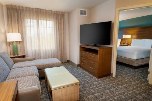 a hotel room with a bed and a television at Staybridge Suites - Nashville - Franklin by IHG in Franklin