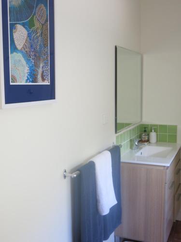 a bathroom with a sink and a mirror and a towel at Sinclair Cottage in Port Lincoln