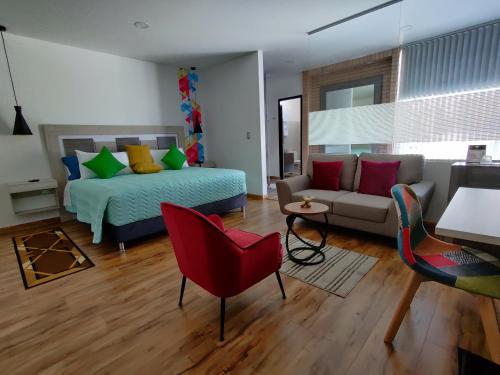 a bedroom with a bed and a couch at Hotel Aristo Gold in Tunja