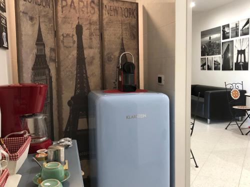 a blue refrigerator in a room with the eiffel tower at Hibiscus in Taranto