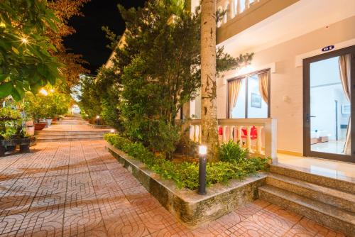 a street at night with a row of trees at Quynh Mai Resort in Phu Quoc