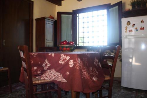 een keuken met een tafel met een rode tafelkleed erop bij Casa Claudia in Marsala