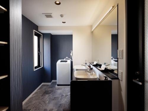 a bathroom with a sink and a white refrigerator at Connect Inn Kyoto Station South in Kyoto