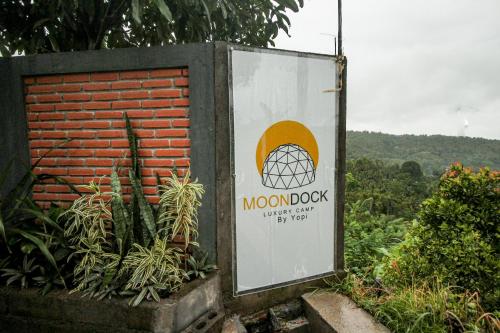 a sign for a moon block on a brick wall at Moondock Luxury Camp in Munduk