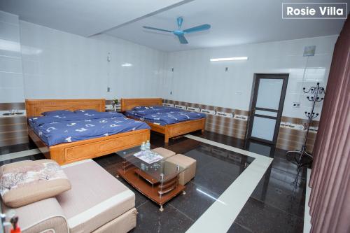 a living room with two beds and a couch at Rosie Villa Ha Giang - Motorbikerental & Tour in Ha Giang