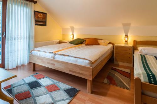 a bedroom with a bed and a dresser and a window at Spacious apartment in Bled