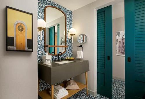 a bathroom with a sink and a mirror at The Monsaraz San Diego, Tapestry Collection By Hilton in San Diego
