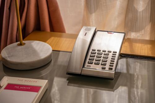 a silver cell phone sitting on top of a table at The Mercer in Hong Kong