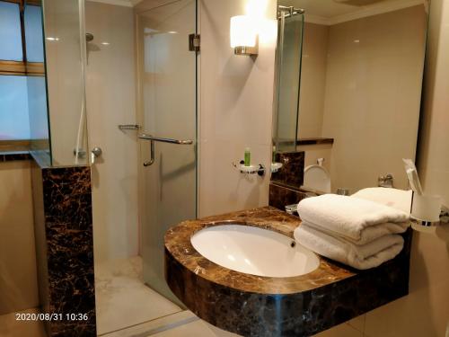 a bathroom with a sink and a shower at Apartemen Puncak Marina in Surabaya