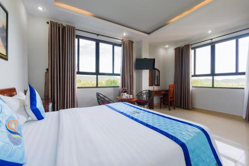 a hotel room with a bed and a desk at Quynh Mai Resort in Phu Quoc