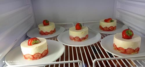a group of cakes on plates in a refrigerator at Logis Hôtel Beauséjour in Berre-les Alpes