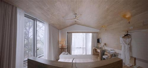a large bathroom with a tub and a large window at Fusion Suites Saigon in Ho Chi Minh City