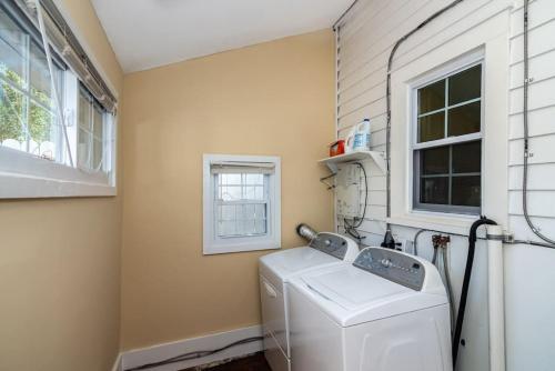 a laundry room with a washing machine and a window at 915CountyLineRoad Luxury Mainline Train Colleges in Bryn Mawr