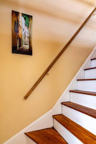 a staircase with a painting on the wall at 915CountyLineRoad Luxury Mainline Train Colleges in Bryn Mawr