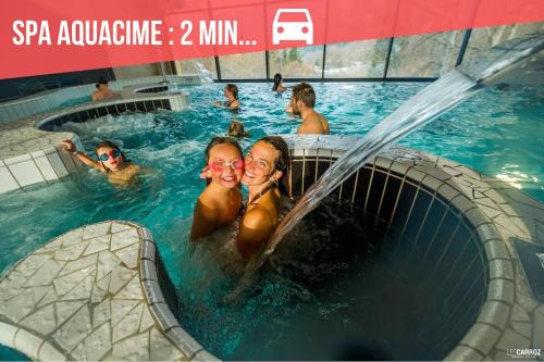a group of people in a swimming pool at RED APPLE CARROZ Duplex de charme WIFI Parking Balcon TV Ski-Bus in Les Carroz d'Araches