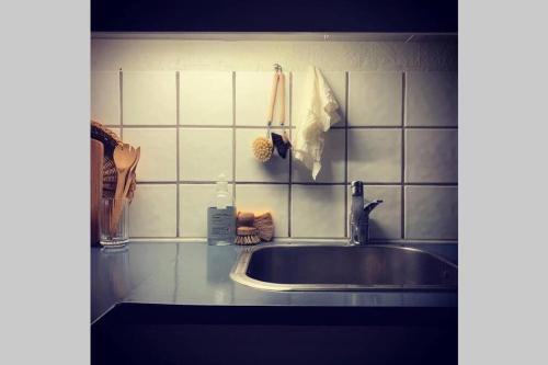 a kitchen counter top with a sink and a counter top at Peddastova in the heart of fishing village Skopun in Skopun