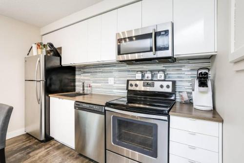 a kitchen with a stainless steel stove and a microwave at Cozy Collingwood Retreat 80204 in Collingwood