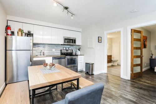 a kitchen with a wooden table and a refrigerator at Cozy Collingwood Retreat 80204 in Collingwood